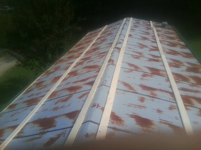 Rusted metal roof panels with new wood purlins before replacement — Storm Damage Roof Repair in Gaston by Roofing Brothers